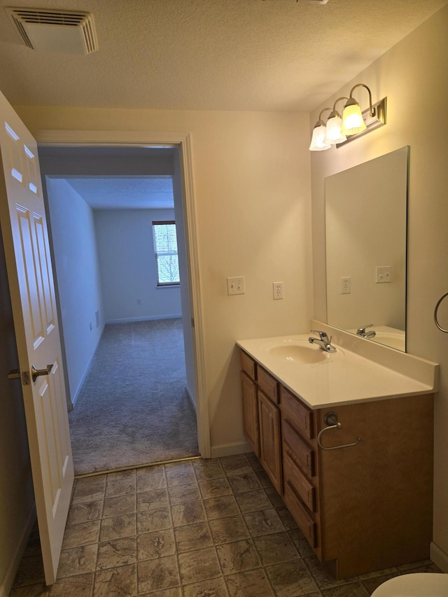 bathroom featuring vanity and a textured ceiling