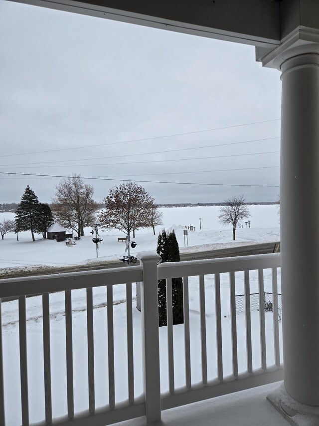 view of snow covered back of property