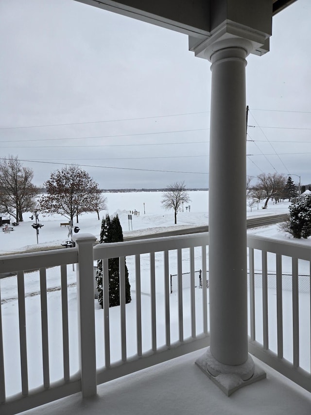 view of snow covered back of property