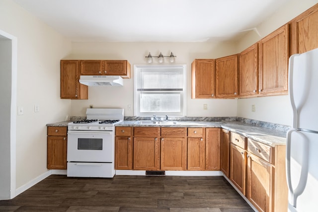 kitchen with sink, white appliances, and dark hardwood / wood-style floors