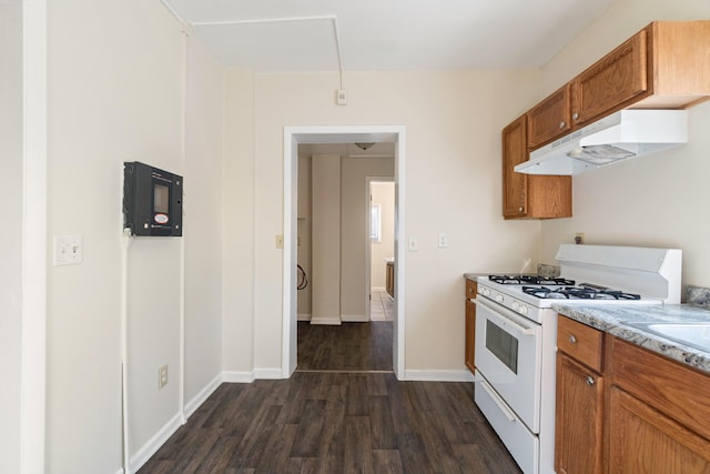 kitchen featuring dark wood-type flooring and white gas range oven