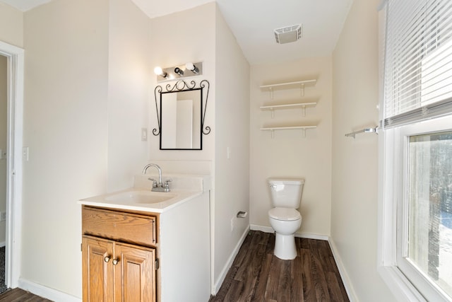 bathroom with vanity, toilet, and wood-type flooring