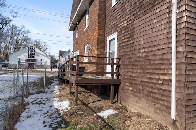 view of snowy exterior featuring a deck