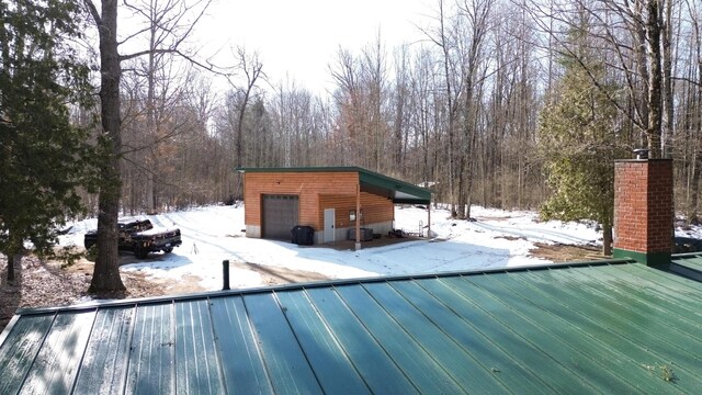 6919 E Free Soil Rd, Free Soil, MI 49411 - snow covered deck with a garage and an outdoor structure