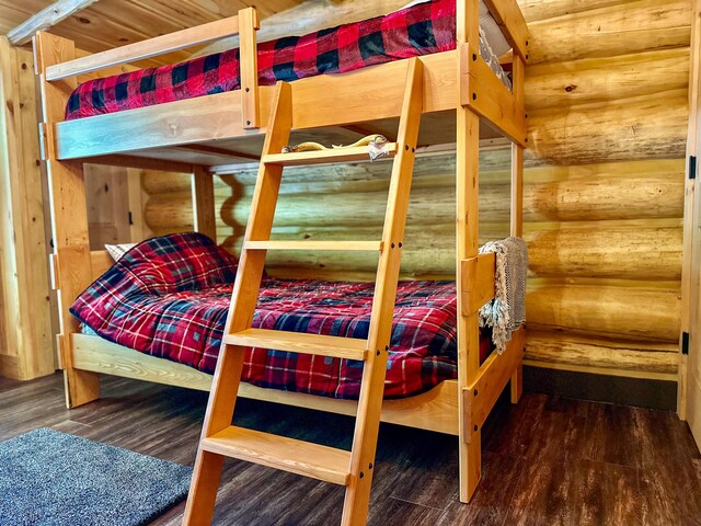 6919 E Free Soil Rd, Free Soil, MI 49411 - bedroom featuring rustic walls and wood finished floors