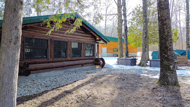 6919 E Free Soil Rd, Free Soil, MI 49411 - rear view of property featuring log siding
