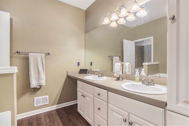 bathroom featuring vanity, wood-type flooring, and an inviting chandelier