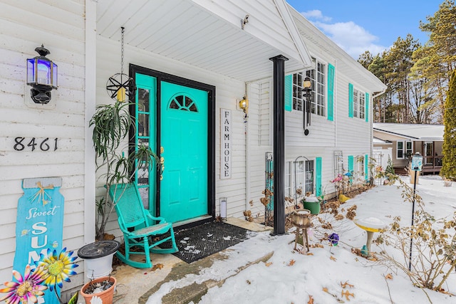 view of snow covered property entrance