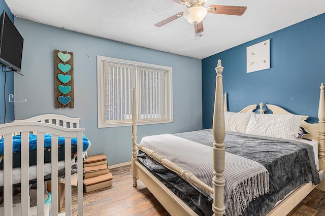 bedroom with hardwood / wood-style floors and ceiling fan