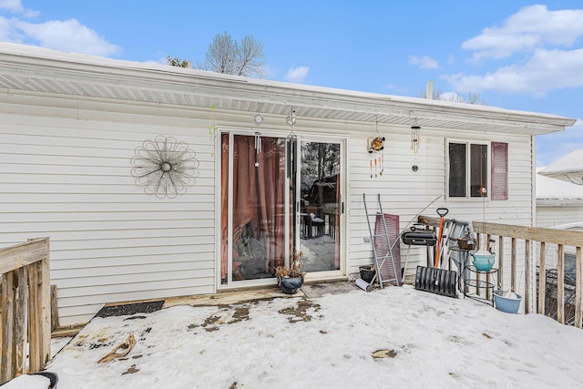 view of snow covered property entrance