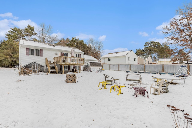 snow covered house with a deck