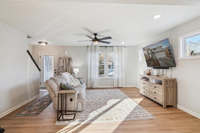 living room with ceiling fan and light wood-type flooring