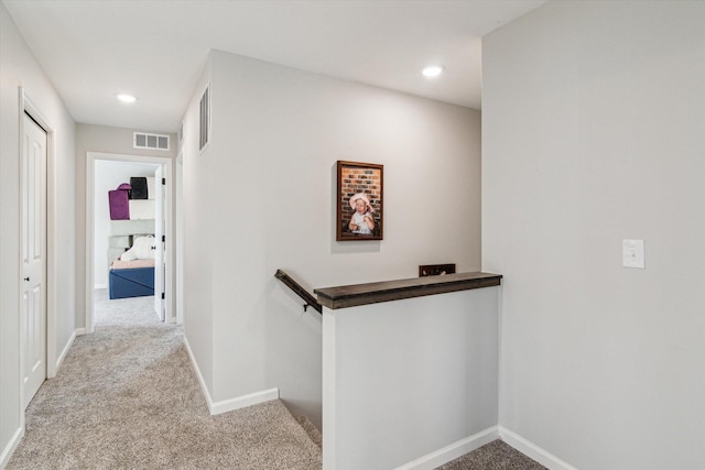 corridor with light colored carpet