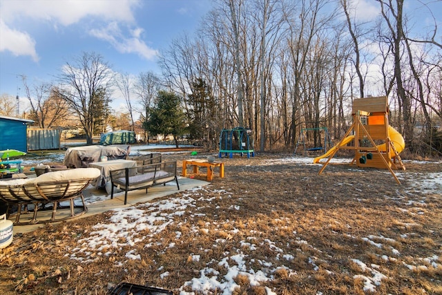 snow covered playground with outdoor lounge area and a trampoline