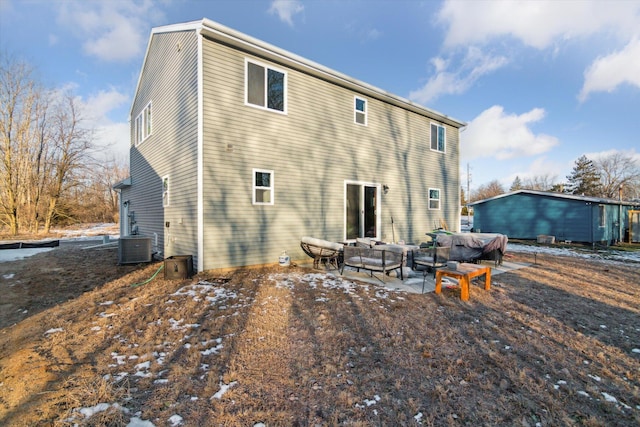 back of house featuring central AC, an outdoor hangout area, and a patio area