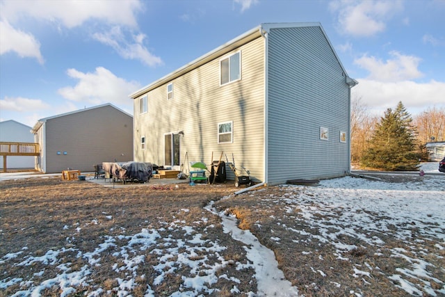 view of snow covered rear of property