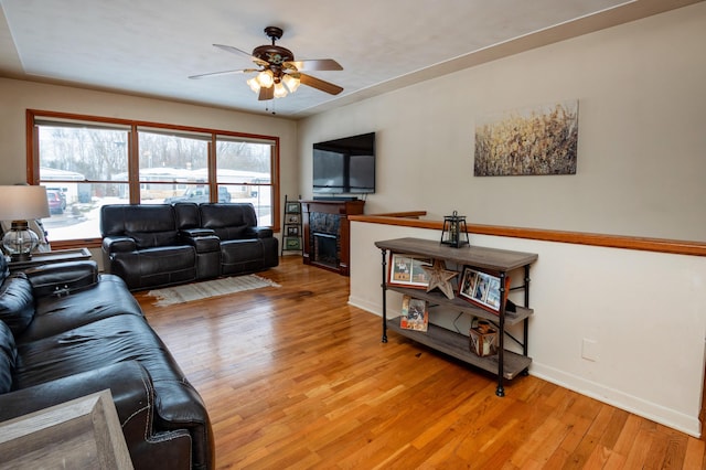 living room with ceiling fan and light wood-type flooring