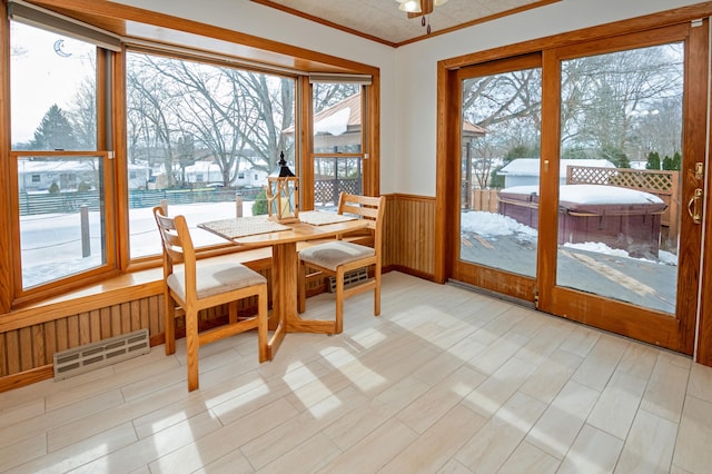 dining area featuring crown molding and wood walls