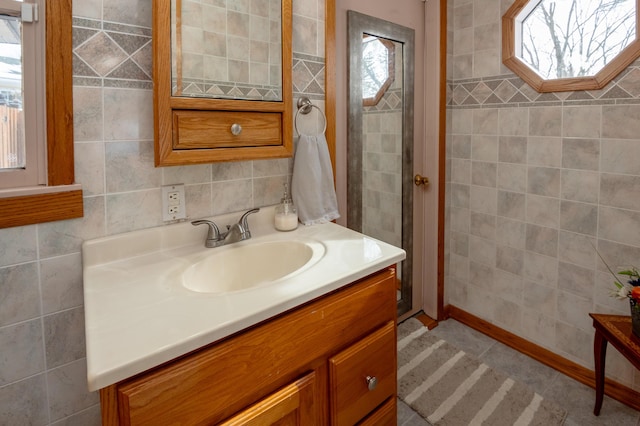 bathroom featuring vanity, a skylight, and tile walls