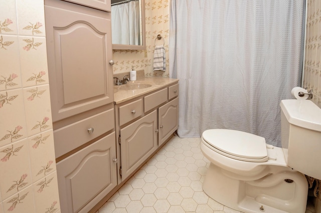 bathroom with vanity, tile patterned floors, and toilet