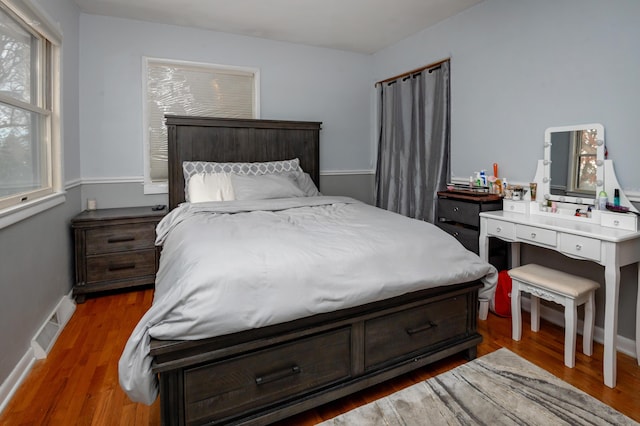 bedroom with dark wood-type flooring