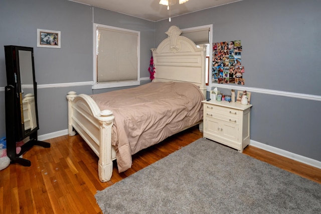 bedroom with dark hardwood / wood-style flooring