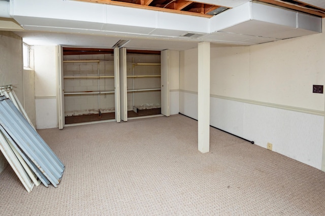 basement featuring light colored carpet