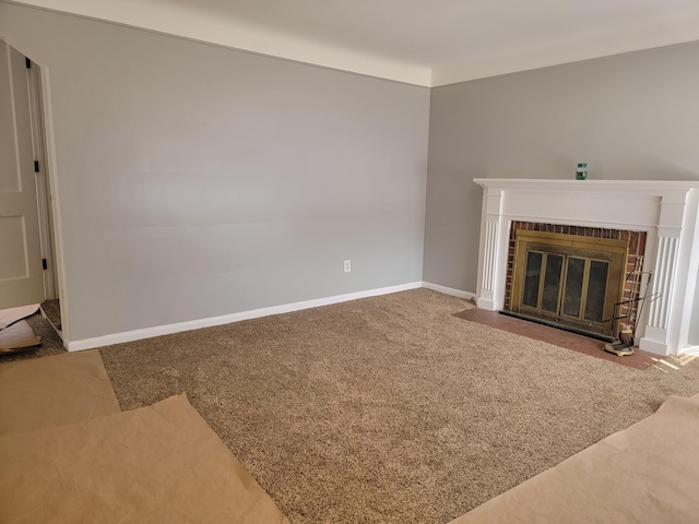 unfurnished living room featuring carpet and a brick fireplace