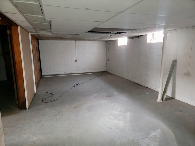 basement featuring a paneled ceiling