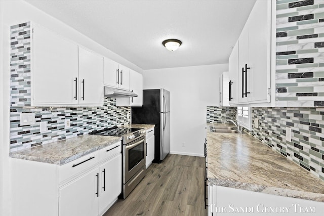 kitchen featuring sink, white cabinets, backsplash, and stainless steel range with electric stovetop