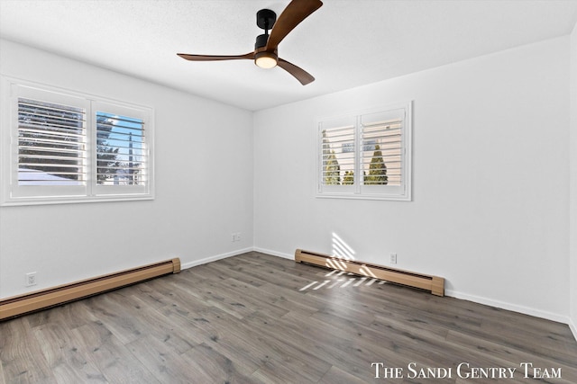 unfurnished room featuring a baseboard heating unit, dark wood-type flooring, and ceiling fan