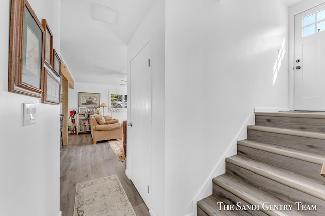 stairs featuring hardwood / wood-style flooring