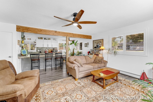 living room featuring plenty of natural light, light hardwood / wood-style floors, and ceiling fan