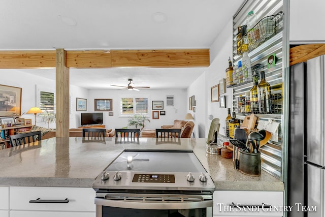 kitchen with white cabinetry, ceiling fan, stone countertops, and electric range