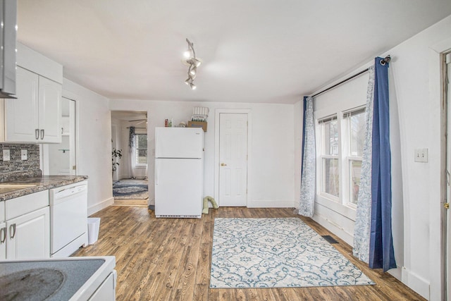 kitchen with white cabinetry, white appliances, and plenty of natural light