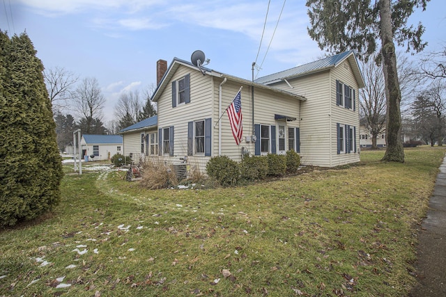 view of home's exterior featuring a lawn and central air condition unit