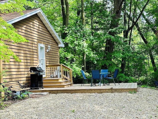 exterior space with outdoor dining space and a wooden deck