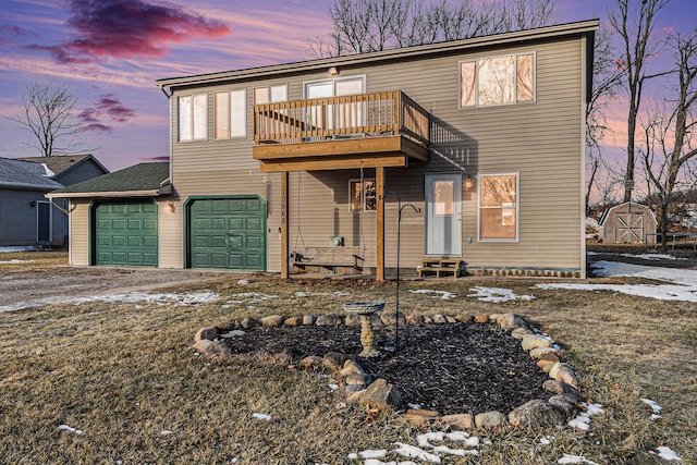 view of front of house with entry steps, driveway, an attached garage, and a balcony