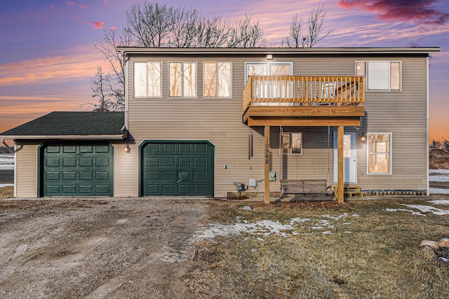 view of front of home featuring driveway, a balcony, and an attached garage