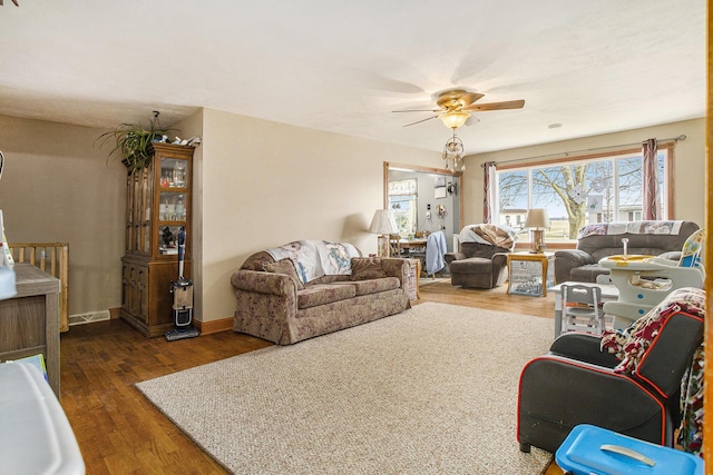 living room with dark hardwood / wood-style floors and ceiling fan