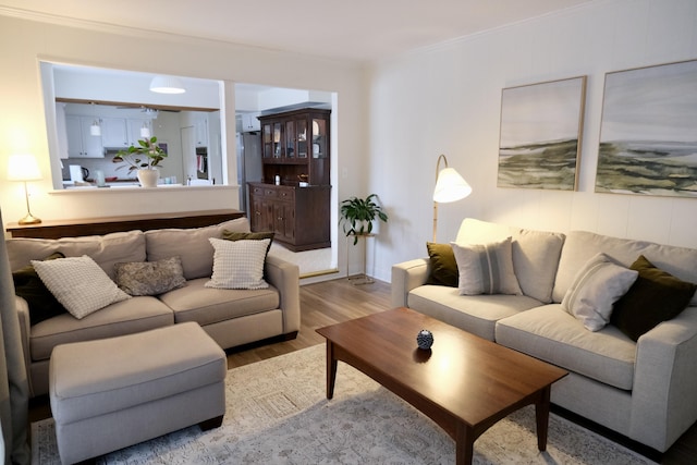 living room featuring crown molding and light hardwood / wood-style floors