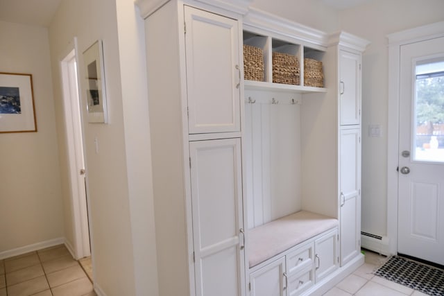 mudroom with baseboard heating and light tile patterned flooring