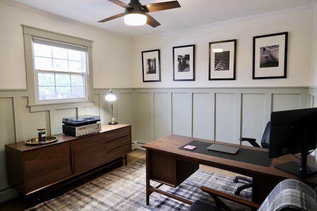 office space with ceiling fan, ornamental molding, and a baseboard heating unit