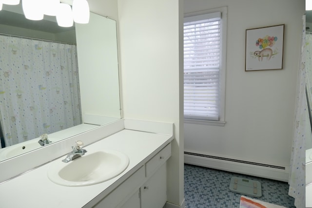 bathroom with vanity, plenty of natural light, and baseboard heating