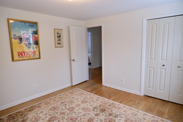 unfurnished bedroom with light hardwood / wood-style floors and a closet