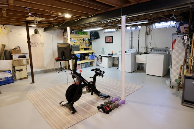 basement with sink, independent washer and dryer, and a workshop area