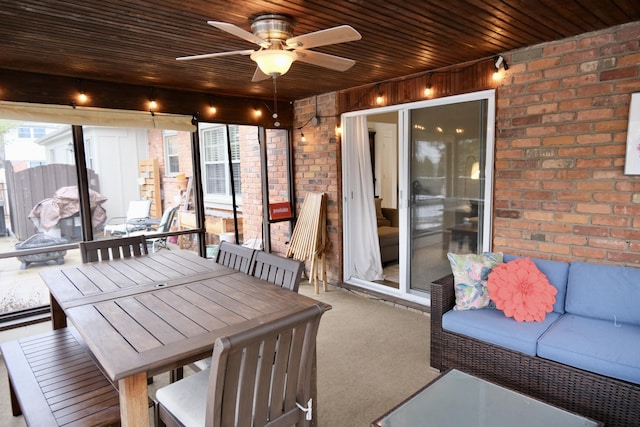 sunroom / solarium with wood ceiling and ceiling fan