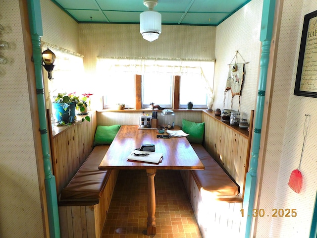 dining space featuring breakfast area and a paneled ceiling