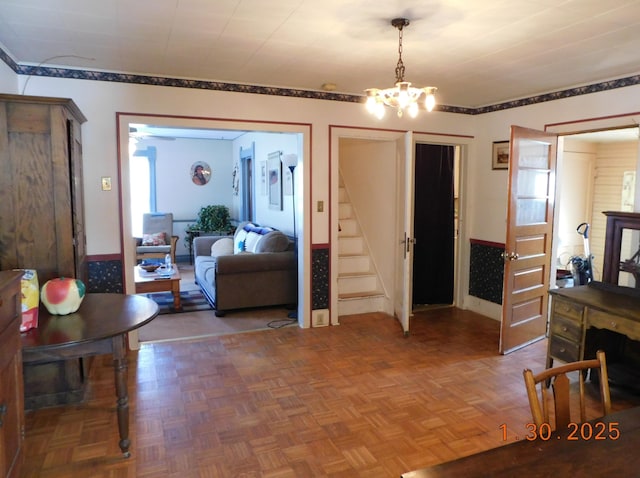 living room with parquet flooring and an inviting chandelier