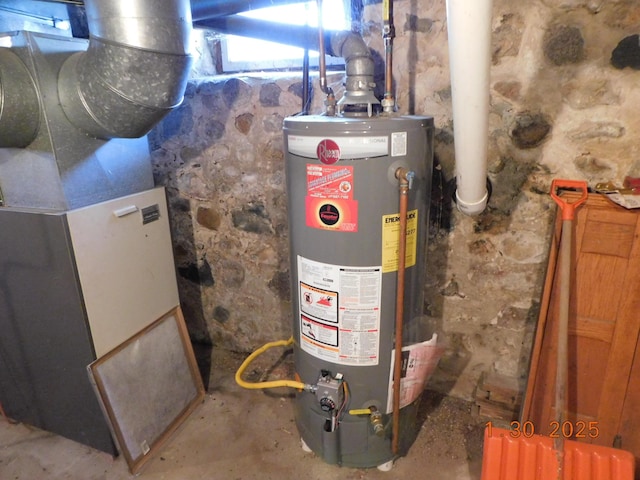 utility room with heating unit and gas water heater